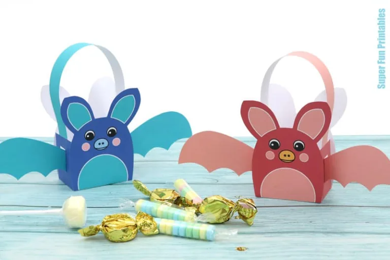 Printable rainbow bat baskets for Halloween treats. Print, cut out and glue the bat template together to fill with small treats. Colour-your-own version available