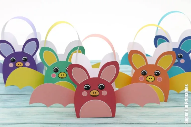 Printable rainbow bat baskets for Halloween treats. Print, cut out and glue the bat template together to fill with small treats. Colour-your-own version available