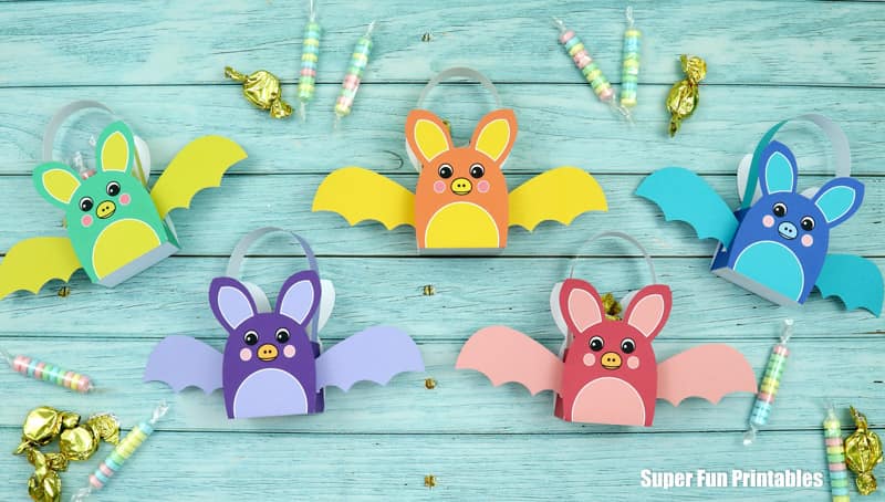 Printable rainbow bat baskets for Halloween treats. Print, cut out and glue the bat template together to fill with small treats. Colour-your-own version available