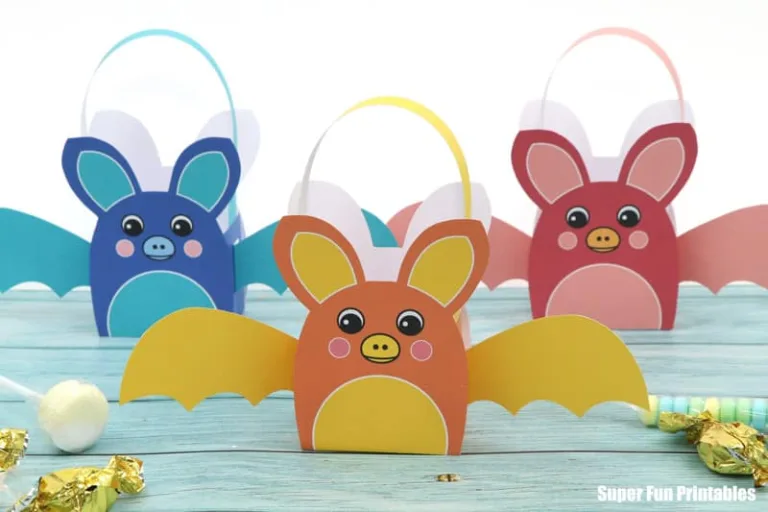 Printable rainbow bat baskets for Halloween treats. Print, cut out and glue the bat template together to fill with small treats. Colour-your-own version available