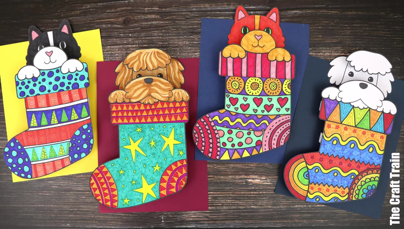 Kids printable art project featuring a kitten or a puppy peeking out of pattern art Christmas stockings