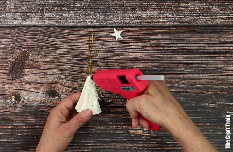 Steps to make egg carton Christmas tree - hot glue a gold star in place