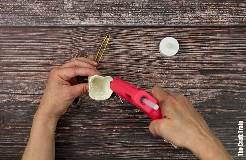 Steps to make egg carton Christmas tree- hot glue your egg carton candle in place