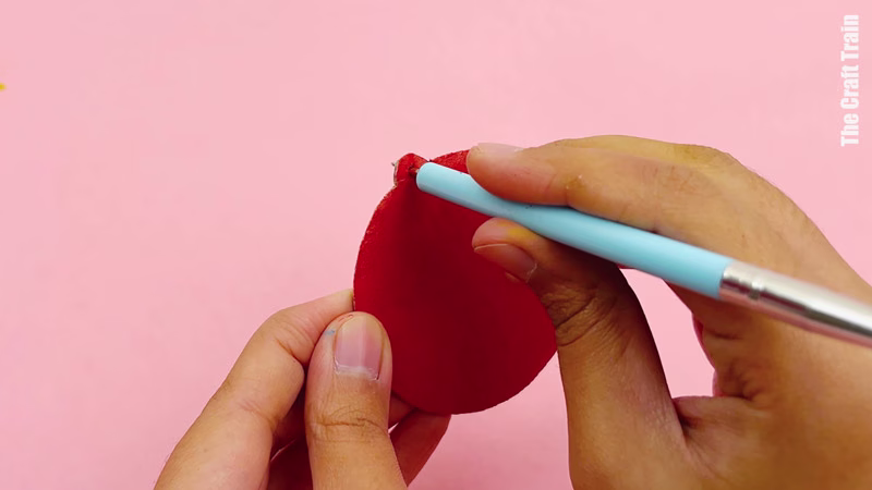 Steps to make cardboard shape decorations. Use a skewer to make a hole in the shapes