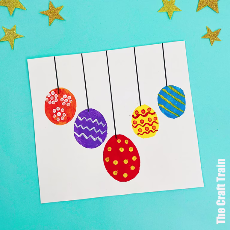 Five colourful circles created with potato stamps have been decorated with q-tip patterns to look like Christmas baubles. Photographed on a blue background with stars