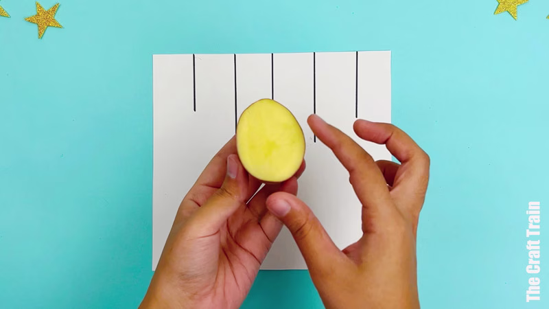 Potato stamp Christmas bauble artwork steps - use a potato cut in half as your stamp