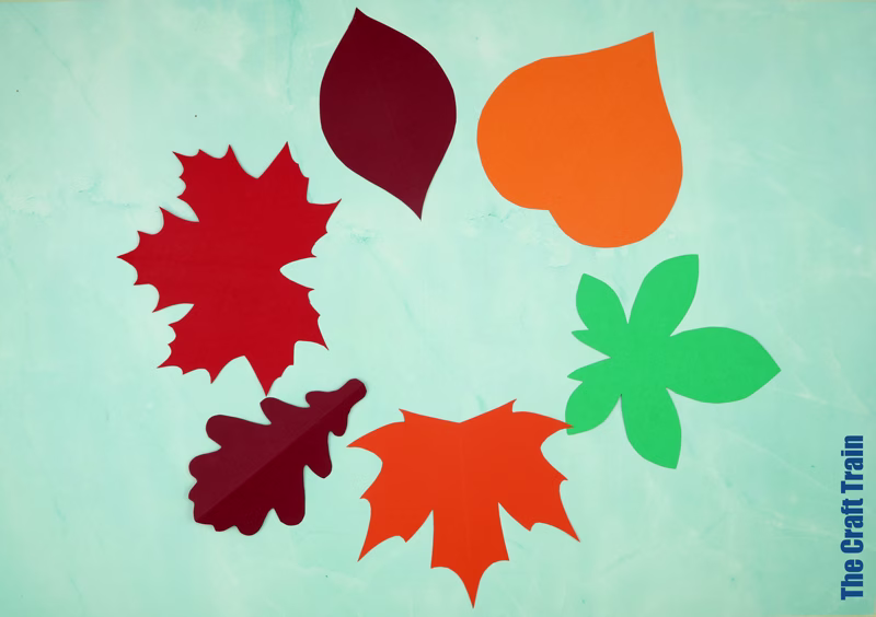 Symmetrical paper leaf templates with a fold-and-cut design